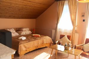a bedroom with a bed and a table at Heviz Therme Apartmenthaus in Hévíz