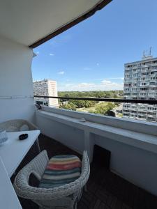 a balcony with a table and chairs and a window at Chic & Cozy Beige Studio in Bratislava