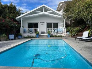 a swimming pool in front of a house at The Joneses in Plettenberg Bay +270 photos