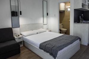 a bedroom with a bed and a chair in it at Albatross Breeze Bungalow 100m from the beach in Varna City