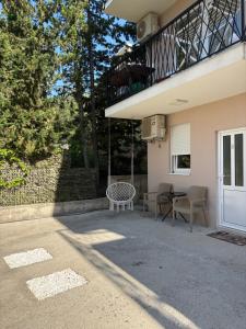 a porch of a house with a swing at Studio apartman Happy Home in Tivat