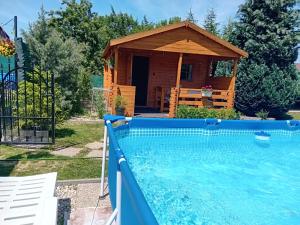 a house with a pool and a gazebo at Rekreačná chatka Oliver in Strečno