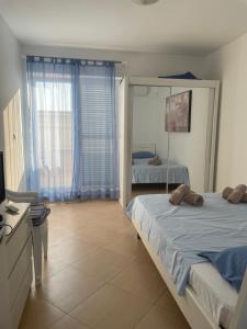 a bedroom with two beds and a mirror at Apartment Lana Maris studio 2 - 200m from beach, terrace with sea view, wi-fi and free parking in Dramalj
