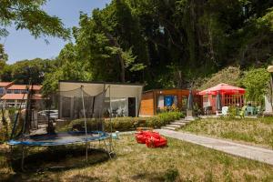 a house with a trampoline in the yard at Albatross Breeze Bungalow 100m from the beach in Varna City +9 photos