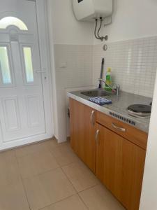 a kitchen with a sink and a counter top at Apartment Lana Maris studio 2 - 200m from beach, terrace with sea view, wi-fi and free parking in Dramalj +14 photos