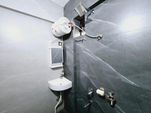 a bathroom with a sink and a mirror and a shower at JSOT Glamping Resort in Kolvan