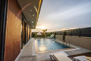 a swimming pool on the roof of a building at Belek Seven Luxury in Belek