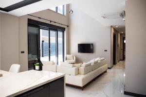 a living room with white couches and a tv at Seven Luxury in Belek