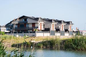 a house on the shore of a body of water at Seven Luxury in Belek