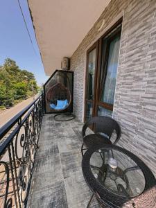 uma varanda com duas cadeiras e uma janela em Hotel Love em Kobuleti