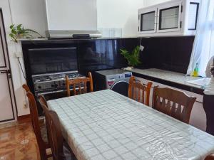 a kitchen with a table and a kitchen with a stove at Sandy Home in Grande Gaube