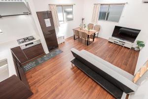 a living room with a couch and a table at 春明House in Tokyo