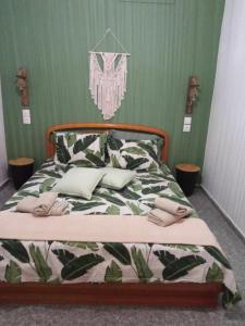 a bedroom with a bed with a green wall at Konstalia in Moúdhros