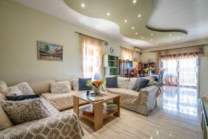 a living room with a couch and a table at Eretria Panorama Seaview Retreat with Balcony in Eretria