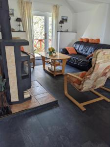 a living room with a fireplace and a couch at Luxe Appartement Hertvíkovice in Vlcice