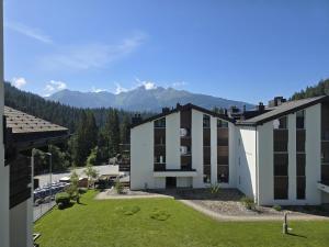 arial view of a building with mountains in the background at LAAX Homes - Casa Allgäu in Laax-Murschetg