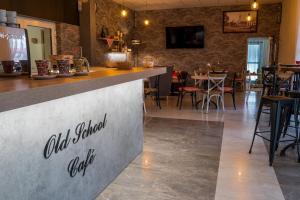a bar in a restaurant with tables and chairs at Old School Inn penzion in Beluša