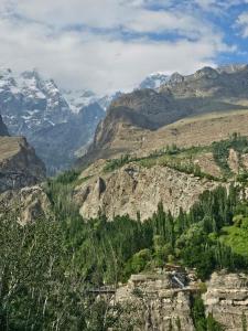 a view of a mountain valley with snow covered mountains at The Backpackers' Nest Hunza in Hunza Valley +8 photos