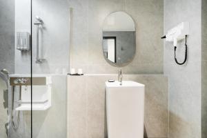a bathroom with a shower and a toilet and a mirror at Hound Hotel Mokpo Peace Plaza in Mokpo +37 photos