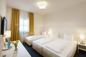 Postel nebo postele na pokoji v ubytování Hotel Wandinger Hof by Lehmann Hotels