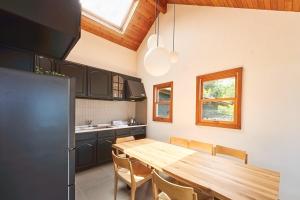 a kitchen with a wooden table in a kitchen at プライベートリゾート飛鳥 in Atami
