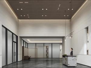 a woman standing in a lobby with a person standing at a counter at Atour Hotel Chongqing Grand Hall Jialing River Riverside Road in Chongqing