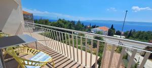 a balcony with a table and chairs and the ocean at Apartmani Mentha & Lipa in Novi Vinodolski