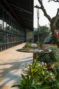 a building with a fountain in the middle of a garden at De Hué in Hue
