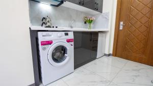 a washing machine in a kitchen with a sink at Elegance Sirius in Kayseri
