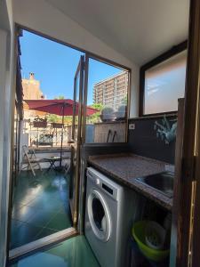 una cucina con lavatrice e lavandino di B&B I Licutiani a Catania