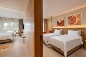 a hotel room with two beds and a desk at Rixos Premium Tekirova - The Land of Legends Access in Tekirova
