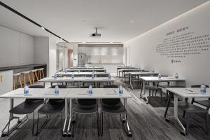 a large room with tables and chairs and a chalkboard at 夏朗酒店 Xialang Hotel&Free ShuttleBus to Guangzhou BaiyunInternational Airpor in Guangzhou