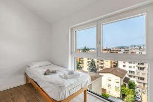 Una cama o camas en una habitación de Viganello Modern Apartments
