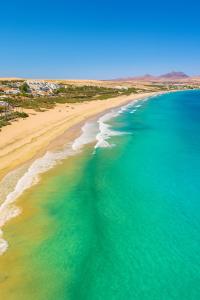 an aerial view of a beach and the ocean at Oasis del Sol in Costa Calma