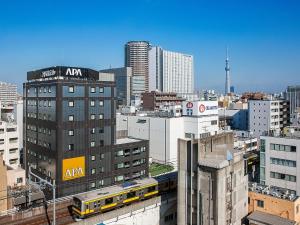 a view of a city skyline with a train at APA Hotel Akihabara Ekimae in Tokyo