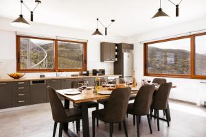 a kitchen and dining room with a table and chairs at Mountain Dream Panorama in Aryiroúpolis