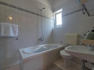 a bathroom with a tub and a toilet and a sink at Apartment house Nena in Krk +15 photos