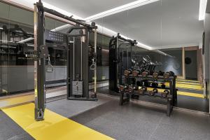 a gym with several racks of weights at 夏朗酒店 Xialang Hotel&Free ShuttleBus to Guangzhou BaiyunInternational Airpor in Guangzhou