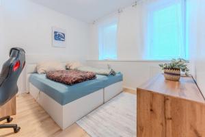 a bedroom with a bed and a table in a room at Apartment in ruhiger Lage in Krems an der Donau