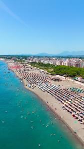 an aerial view of a crowded beach with umbrellas and crowds at Green Villa in Velipojë