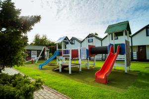 a group of playground equipment in a yard at Dom Wakacyjny Zielone Wzgórze in Mielno