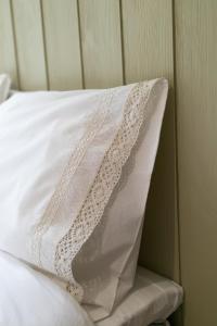 a white pillow sitting on top of a bed at Majatalo Kukkasrinne in Lahti
