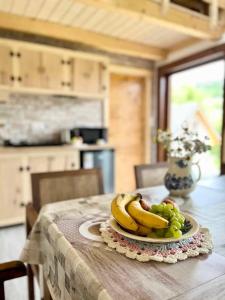 a plate of bananas and grapes on a table at Domki Nad Bocianim Gniazdem in Bukowiec +7 photos