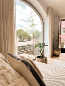 a bedroom with a bed and a large window at Nature LOFT MOLN in Kinrooi