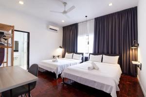 a hotel room with two beds and a window at Bukit Damansara Terrace in Kuala Lumpur