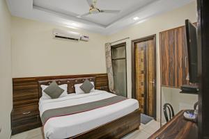 - une chambre avec un lit et une télévision dans l'établissement Hotel O COZY RETREAT, à Indirapuram