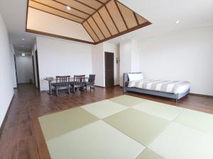 a room with a bed and a table and chairs at Kariyushi Condominium Resort Sea Side House in Nago +118 photos