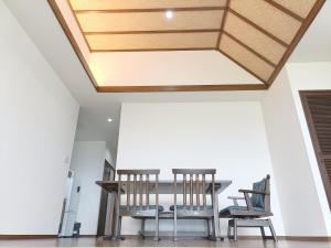 a dining room with a table and chairs at Kariyushi Condominium Resort Sea Side House in Nago