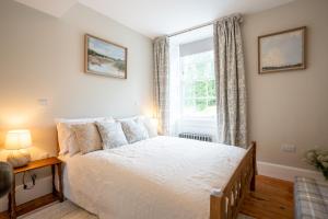a bedroom with a bed and a window at Penninghame Estate - Earl's Library in Challoch