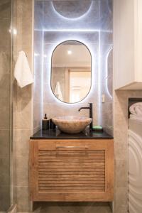 a bathroom with a bowl sink and a mirror at Georgia studio in Chios